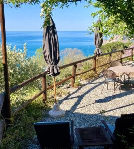 a patio with an umbrella and a table and chairs at Villa Pietrafiore in Monterosso al Mare
