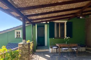 a patio with a table and chairs under a wooden pergola at Villa Pietrafiore in Monterosso al Mare