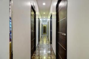 a corridor of a hotel with wooden doors and a long aisle at Hotel Shabana - Colaba Causeway in Mumbai