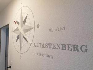 a sign on a wall with a star on it at Ferienwohnung Astenrefugio in Winterberg