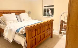 a bedroom with a wooden bed and a window at Thalassa in Dundrum