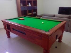 a pool table with balls on it in a living room at Villa Aris in Ayios Theodhoros