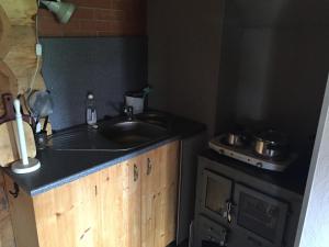 a kitchen with a sink and a stove at Vällamäe talu puhkemaja in Haanja