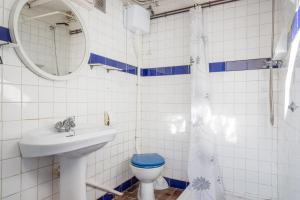 a bathroom with a sink and a toilet and a mirror at Ca l'Estany Clos in Tamariu