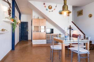 a kitchen and dining room with a table and chairs at Ca l'Estany Clos in Tamariu +17 photos