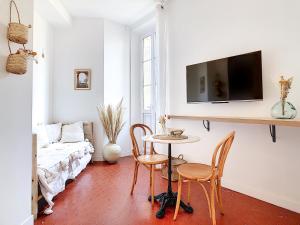 馬賽的住宿－- Maison ÛMA - Wifi, Netflix, Mer et Centre，客厅配有桌椅和沙发