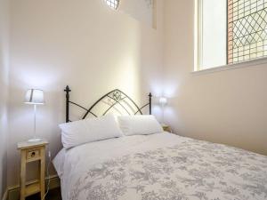 a bedroom with a bed and a window at 4 bed property in Isle of Bute 85215 in Kilchattan