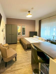 a hotel room with a bed and a desk and a bed at Trip Inn Boutique Rubens in Essen
