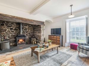 a living room with a stone wall and a fireplace at 3 bed in Corwen 86266 in Corwen