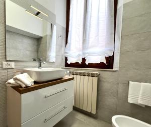 uma casa de banho com um lavatório e um espelho em mazzini101apartment em Ferrara