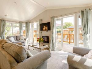 a living room with two couches and a fireplace at 2 bed property in Okehampton 86870 in Okehampton