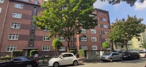 a brick building with cars parked in front of it at Exceptional short-term rental in Düsseldorf