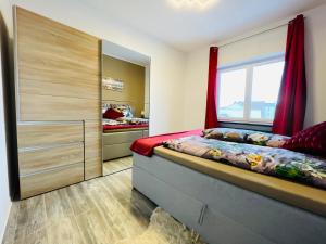 een slaapkamer met een bed en een groot raam bij Ferienwohnung Michelangelo Stadtmitte "Netflix" in Eisenach