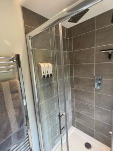 a bathroom with a shower with a tub at Arniss Farmhouse in Fordingbridge +32 photos