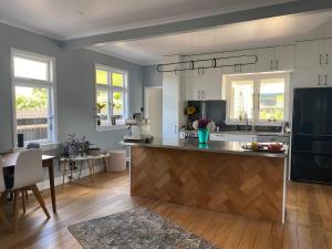 a kitchen with a large island in the middle at Stay@10 in Blenheim