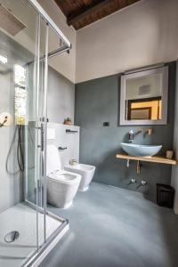 a bathroom with a shower and a toilet and a sink at Locanda Leonardo Hotel in Calolziocorte