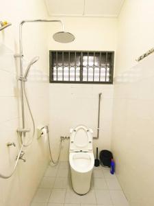 a white bathroom with a toilet and a shower at Southkey Mid Valley , Karaoke, Table Football in Johor Bahru
