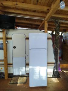 two white refrigerators are sitting in a garage at каравана Марбея in Chernomorets
