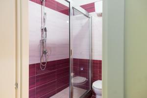 a bathroom with a glass shower with a toilet at LA MASCHERA DI PULCINELLA in Naples +36 photos