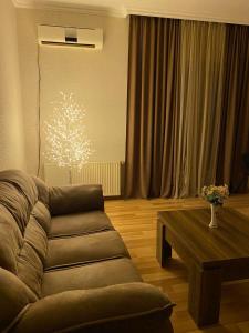 a living room with a couch and a coffee table at City Center Apartment in Kutaisi