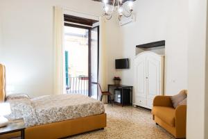 a bedroom with a bed and a couch at LA MASCHERA DI PULCINELLA in Naples
