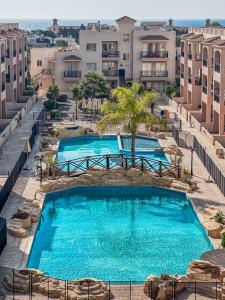 an overhead view of a swimming pool in a resort at Royal-Seacrest Paphos-Center VIP in Paphos City