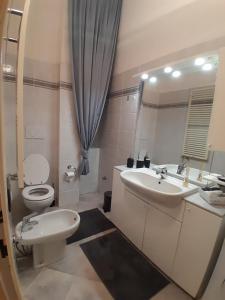 a bathroom with a toilet and a sink and a mirror at appartamento Martina, silenzioso a 100 metri dalla metropolitana in Milan +9 photos