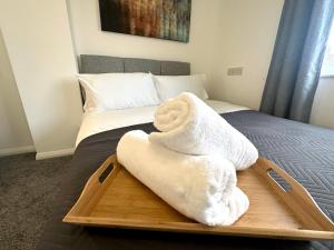 a tray with towels on top of a bed at Sandringham House by Blue Skies Stays in Middlesbrough