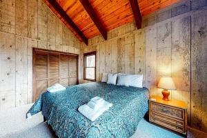 ein Schlafzimmer mit einem Bett und einer Holzwand in der Unterkunft The Treasure of Beech Mountain in Beech Mountain