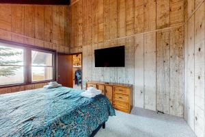 ein Schlafzimmer mit einem Bett und einem TV an der Wand in der Unterkunft The Treasure of Beech Mountain in Beech Mountain