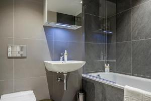 a bathroom with a sink and a shower and a toilet at Apartments in Lake District in Backbarrow