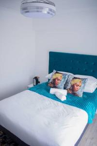 two dolls sitting on top of a bed at 2 Bedroom Apartment with Modern Finishes Hill Tud Stays in Pietermaritzburg