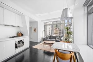a kitchen and living room with a table and chairs at Financial District 1br w WD gym elevator NYC-1361 in New York