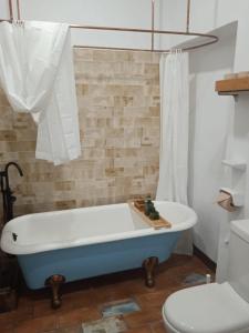 a bathroom with a bath tub and a toilet at La gota de leche 4 in Sanlúcar de Barrameda +10 photos