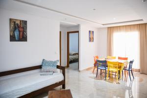 a living room with a table and chairs at Residence Trust in Sousse