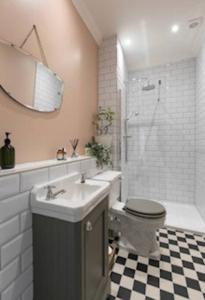 a bathroom with a toilet and a sink and a shower at Walpole View - Pet Friendly in Margate