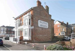 a brick building with a sign on the side of it at Walpole View - Pet Friendly in Margate
