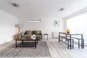 a living room with a couch and a table at The Walthamstow Collection in London