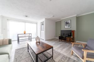 a living room with a couch and a table at The Walthamstow Collection in London