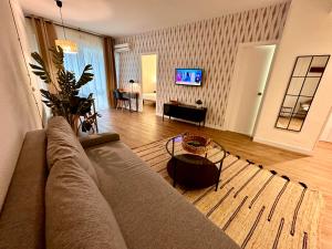 a living room with a couch and a table at Far Home Gran Vía in Madrid