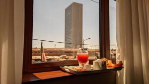 a tray with a drink on a table with a window at Atmosphere Hotel & Spa in Antananarivo