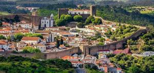 a town on a hill with a castle at VISTA MAR in Lourinhã