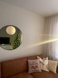 a living room with a couch and a mirror at Your Lapland Adventure Base in Rovaniemi