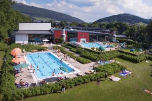 a large swimming pool with people in a resort at Ferienhaus Hedrich in Assinghausen