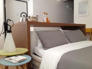 a bedroom with a bed with a wooden headboard and a table at 2409 parma in Parma