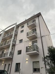 a white building with balconies on the side of it at Residence Rimini Relax in Rimini