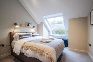 a bedroom with a bed with two towels on it at Apartments in Lake District in Backbarrow