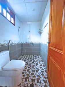 a bathroom with a toilet and a shower at The Hillside Homes in Phong Nha