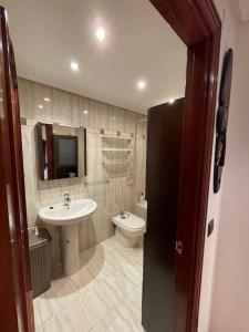 a bathroom with a sink and a toilet at Bonito piso con aparcamiento a pie de la calle . in Nájera