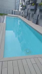 a large blue swimming pool on top of a building at Soleado in Buenos Aires